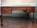 a wooden desk with a drawer underneath it on a hard wood floor