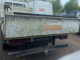 a truck that is parked in a lot with other cars