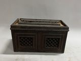 an old wooden box with a decorative design on top of it
