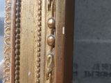 an image of a close up of a mirror with a gold frame