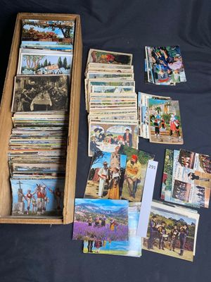 a wooden box filled with cards and pictures on a table