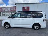 a white minivan parked in front of a building