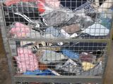 a metal cart with many items in it in a warehouse