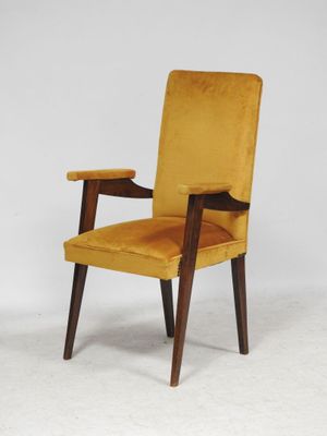 a close up of a chair with a yellow upholstered seat