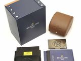 a box with a watch, wallet, and other items on it
