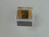 a gold ring with a diamond in it on a white surface
