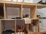 a wooden shelving with many boxes on top of it