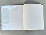an open book on a table with a map of the world in it