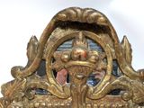 a mirror with a gold frame with a dragon on it