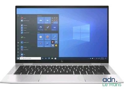 the laptop is open on a white surface with windows on the screen
