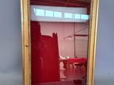 a mirror that is sitting on the floor in front of a wall