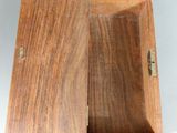 a small wooden box with a lid on a table