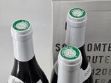 two bottles of wine sitting next to each other on a table