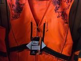 an orange vest with a black and white design on it