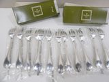 a lot of forks and spoons that are wrapped in plastic