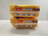 two packages of baby diapers sitting on top of a table