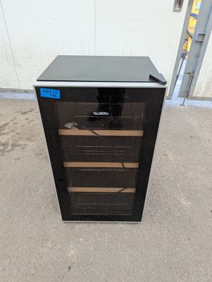 an image of a wine cooler sitting outside of a building