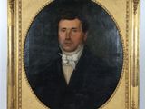 portrait of a man in a black suit with a white bow tie