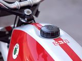 a red and white motorcycle parked on the side of the road