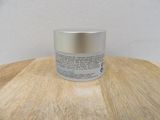 a close up of a jar of cream on a wooden table