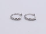 a pair of silver hoop earrings on a white background