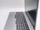 a silver laptop computer sitting on top of a white table