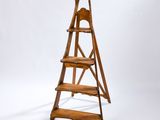 a wooden ladder that is standing up against a white background