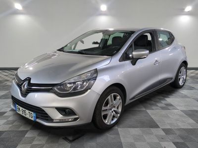 a silver car is parked in a room with a checkered floor