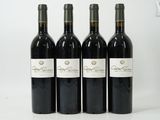 three bottles of wine are lined up on a white surface