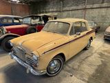 many old cars parked in a garage next to each other