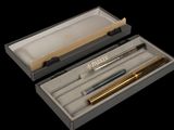 a box with a pen and a pencil inside of it