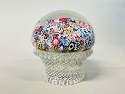 a small glass bowl with a colorful flower design on it