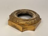 an image of a gold plate with a ring on top of it