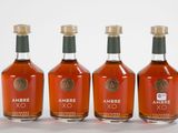 three bottles of ambre xo are lined up in a row
