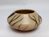 a small vase that is sitting on a white surface