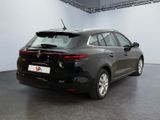 the rear end of a black car in a showroom