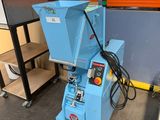 a blue machine that is sitting in a room