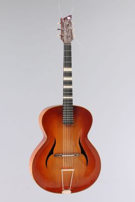 an image of a guitar that is on a stand
