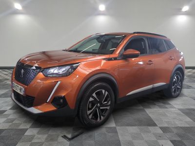 a orange suv parked on a checkered floor in a garage