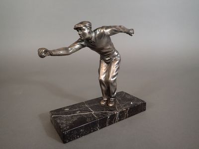 a statue of a man throwing a baseball on a marble base