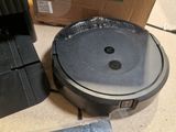 a robot vacuum that is sitting on the floor next to a box