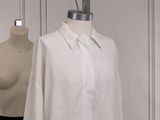 two mannequins and a white shirt on a mannequin stand