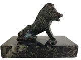 statue of a dog sitting on a marble base on a white background