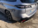 the rear end of a silver car parked in a parking lot