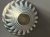 a brown and white bowl on a table with writing on it