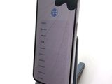 a phone that is sitting on a stand on a table