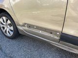 a close up of the side of a car that has been dented