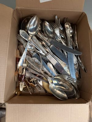 a box full of silver spoons and spoons in it