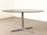 an image of a round table with a metal base and a glass top