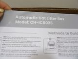 a box with instructions for the automatic cat litter box